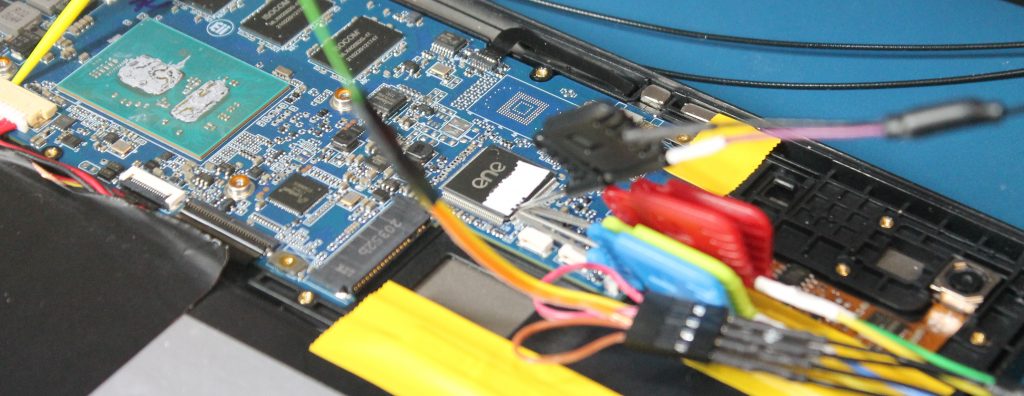 Back of Librem 11, mainboard exposed, with probes connected to the embedded controller chip