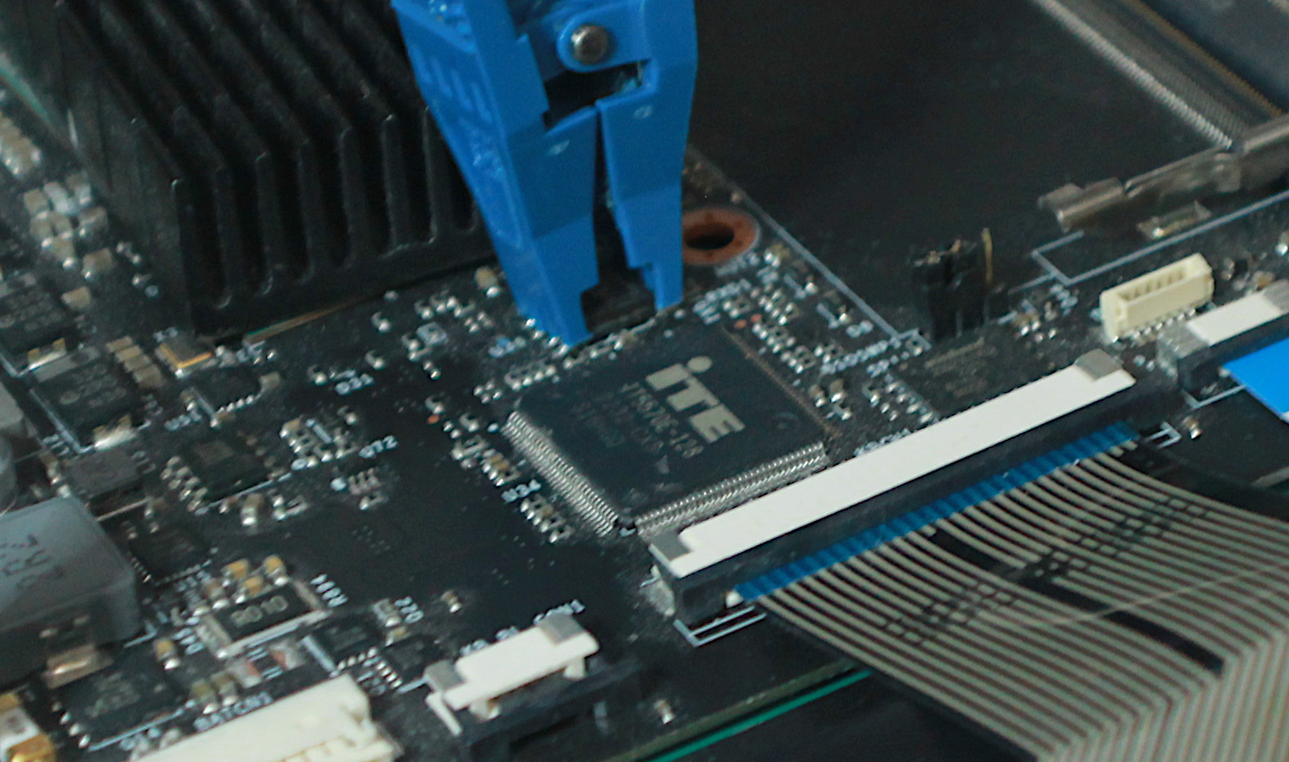 Photo of Librem 16 development board, with flashing clip attached to EC flash