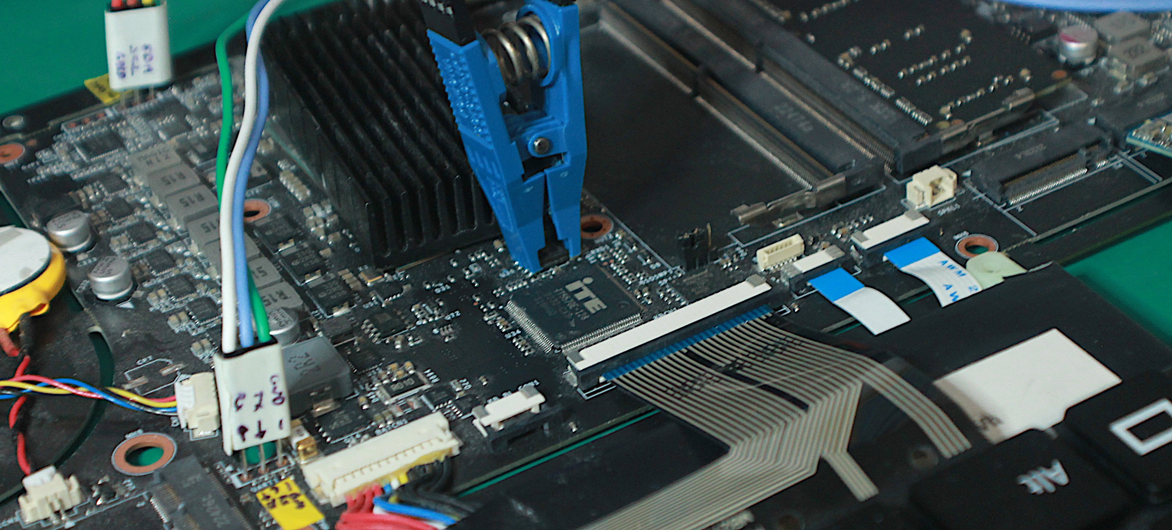 Photo of Librem 16 development board, with flashing clip attached to EC flash